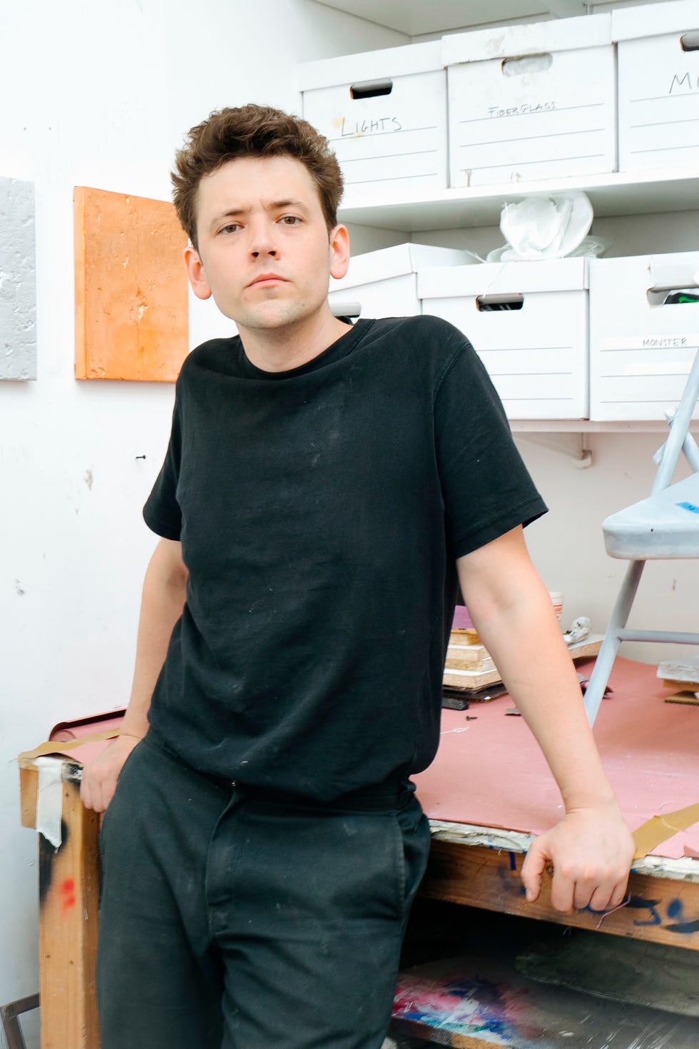 a person posing in a creative workspace