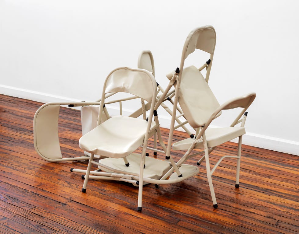 stacked folding chairs on a wooden floor
