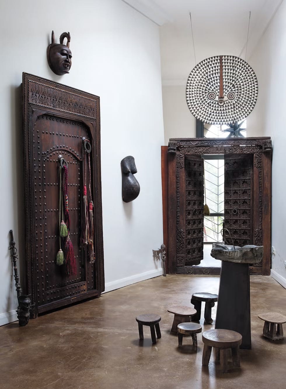 a room featuring traditional wooden artifacts and a unique seating arrangement