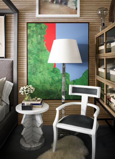white geometric chair and table with artwork behind