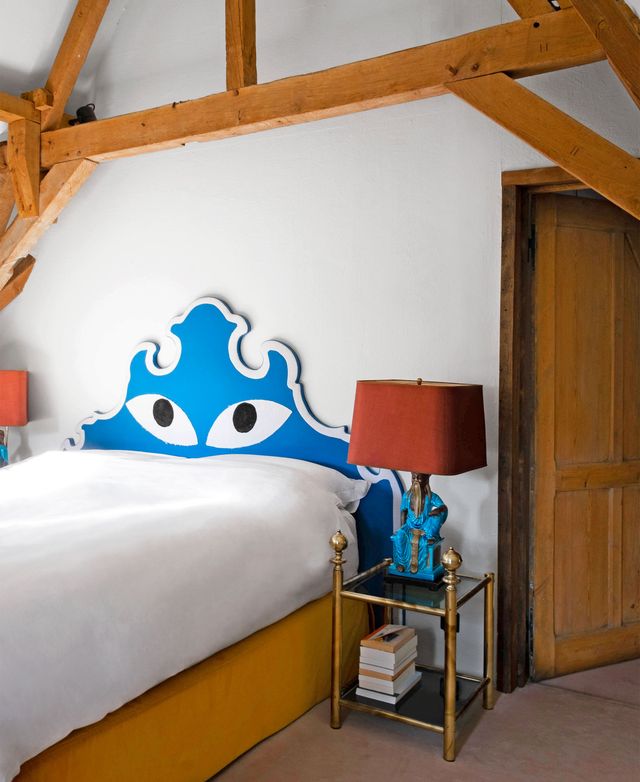 bed with headboard that has eyes drawn on it
