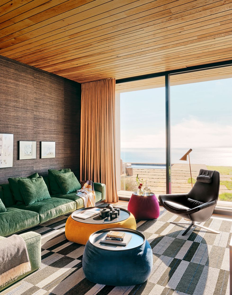 living area with green sofa and blue chairs by sliding door looking outside to sweeping view