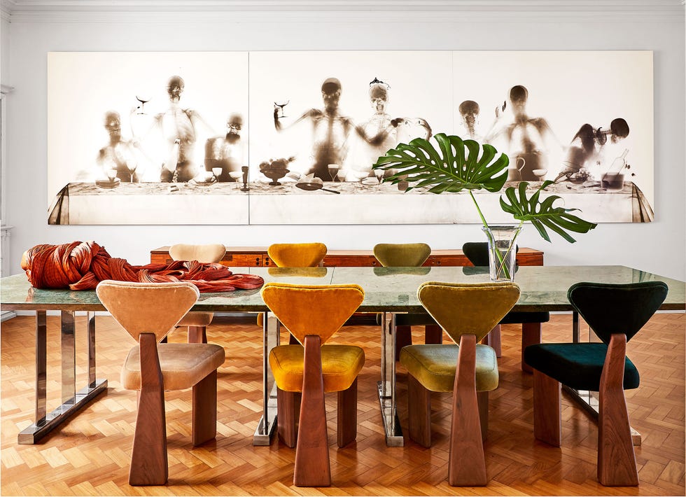 dining room with long table and large wall artwork behind it