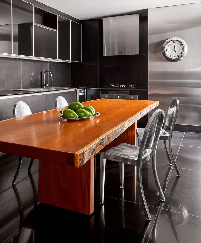 wooden table and chairs in a stainless gray kitchen
