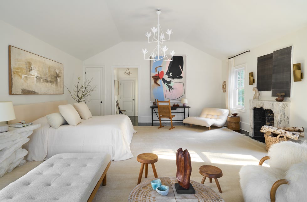 bedroom with modern bed, desk and white chandelier.