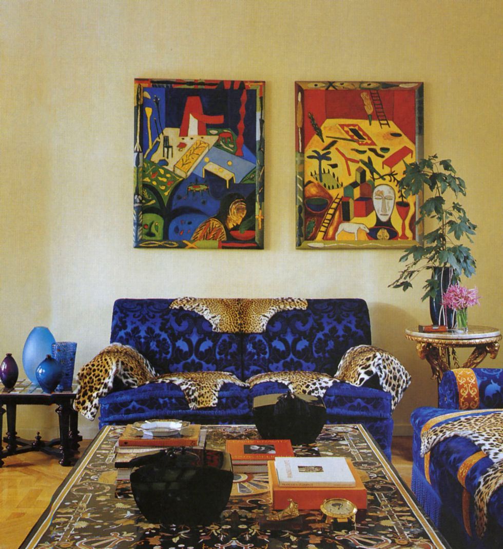 a living room with a couch and art on the wall
