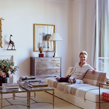 lee radziwill in the living room of her paris apartment with her cockapoo zinnia the sofa is one of christian liaigres early designs and the steel commode gilded bronze cocktail tables and giraffe sculpture are vintage