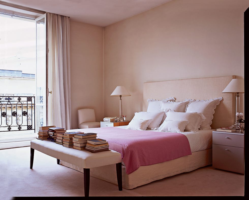 a modénature bench and bedding by d porthault in the master bedroom