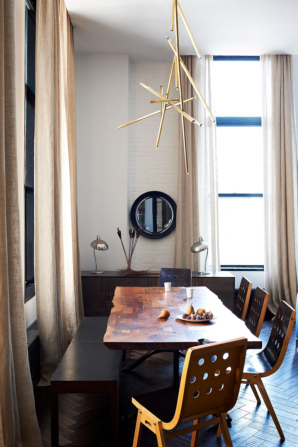 the dining areas table bench and credenza are all by bddw and the vintage chairs are by roland rainer the hanging light fixture is by billy cotton and the curtains are of a linen by ralph lauren home