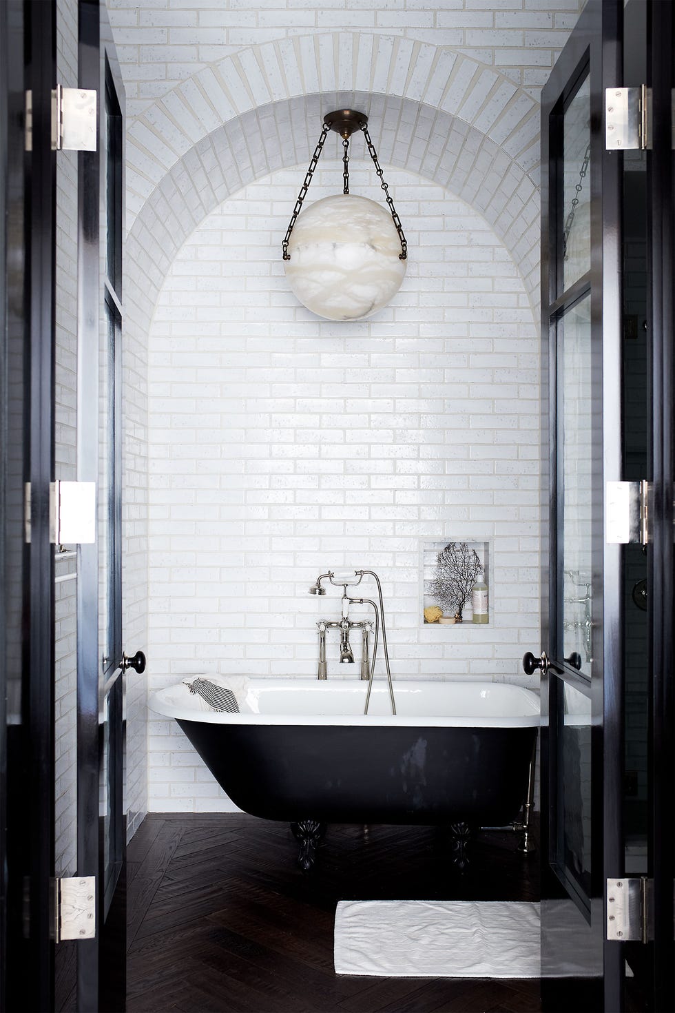 the tub fittings and tiles in the master bath are all by waterworks and the vintage light fixture is from jf chen