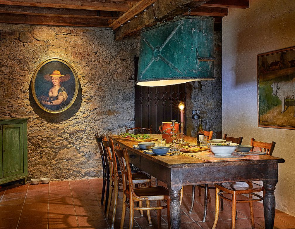 rustic table in dining room with stone walls