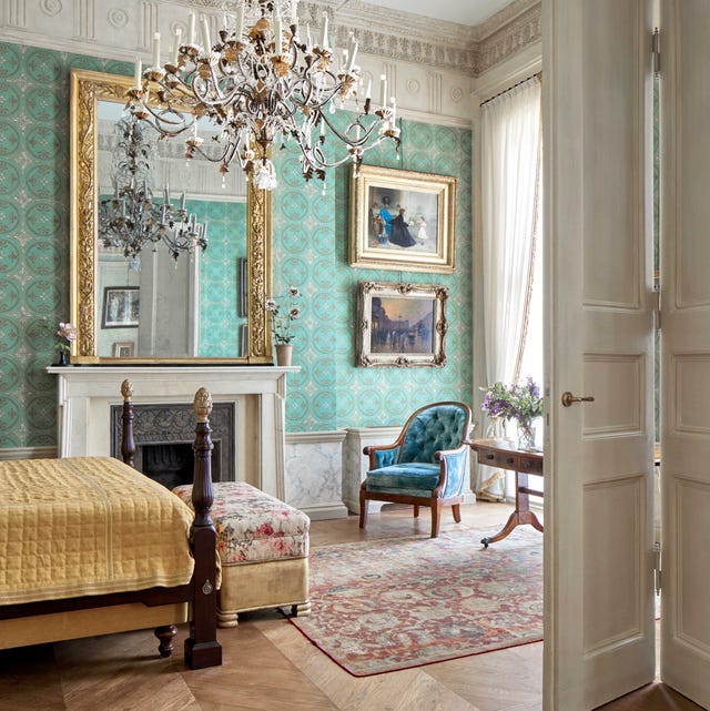 bedroom with aqua wallpaper and an ornate fireplace designed by studio peregalli