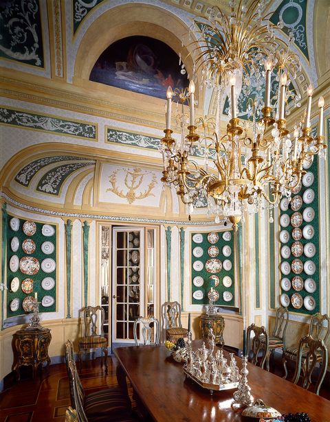 dining room with large table and plates lining the walls