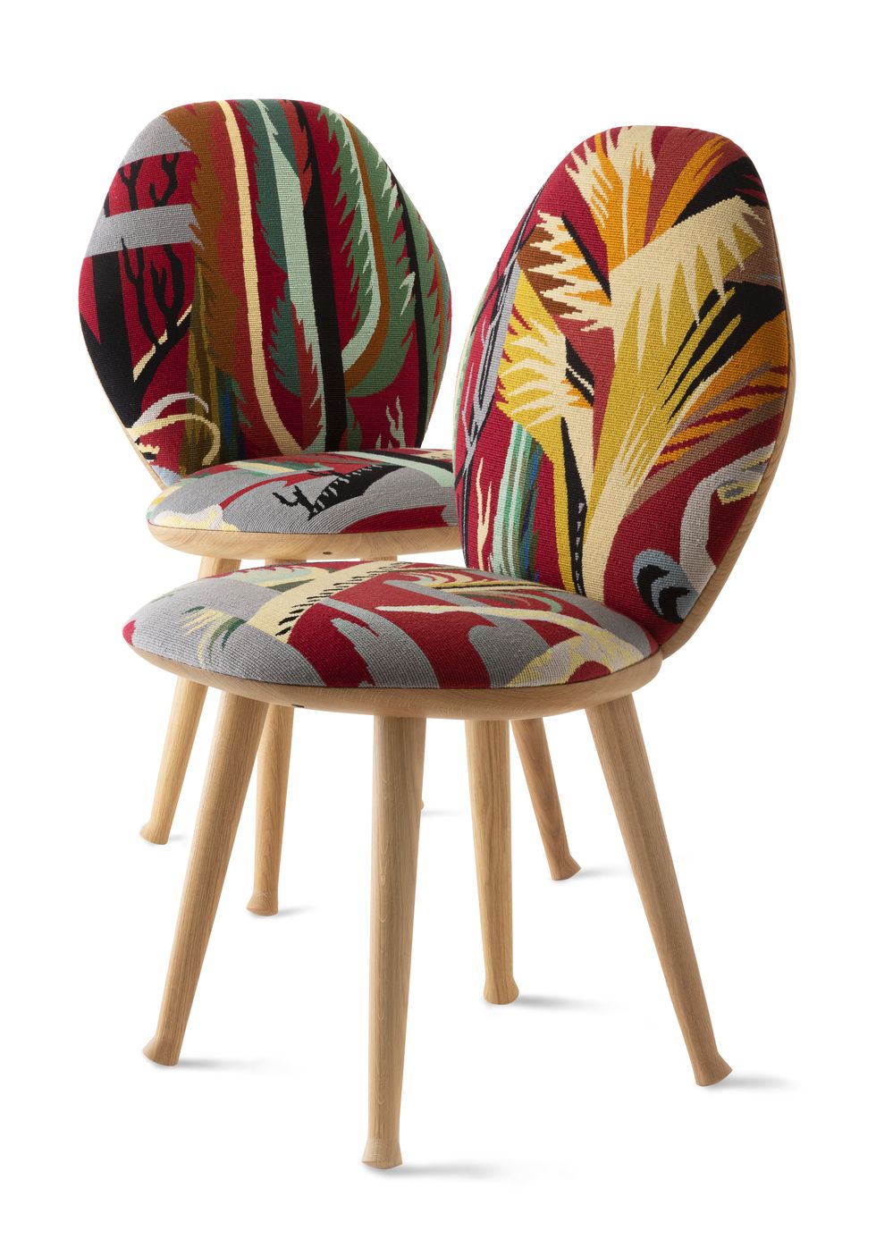 two colorful wooden chairs at right angles to each other with colorful patterned oval backs