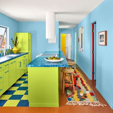 blue and lime green kitchen with speckled blue countertop and long colorful runner