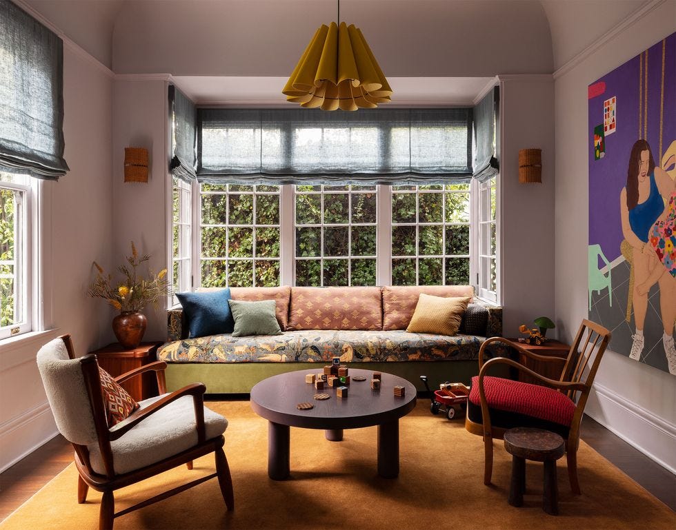 a living room with a couch and chairs