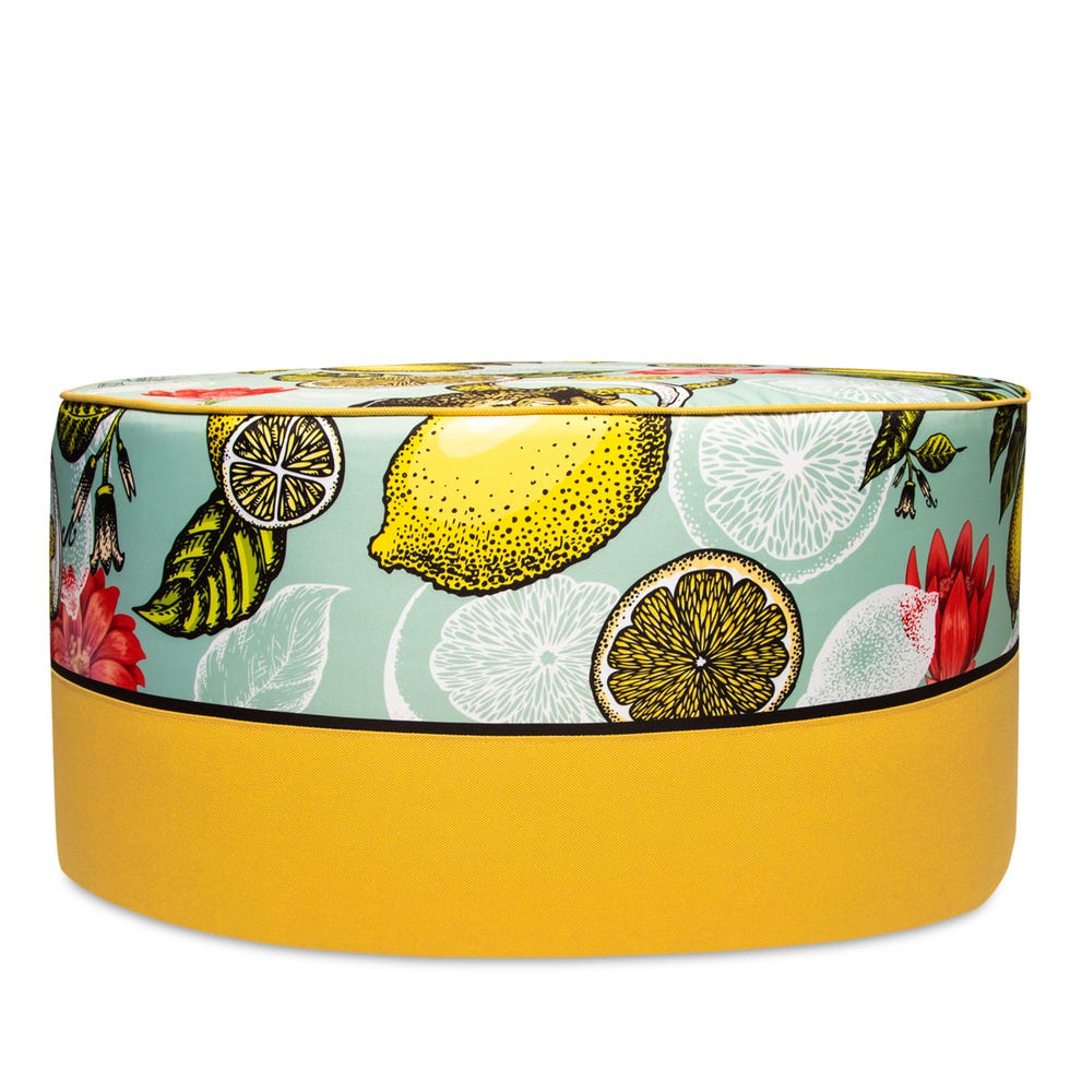 ottoman pouf with a lemon yellow bottom and a patterened top with artistic stylized funky lemon slices and whole lemon design