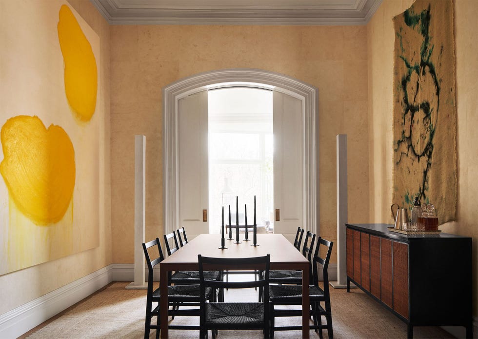 a dining room with a table and chairs