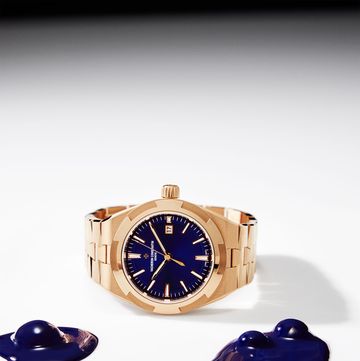 a gold tone watch with blue lapis face and some similar blue blobs next to itl