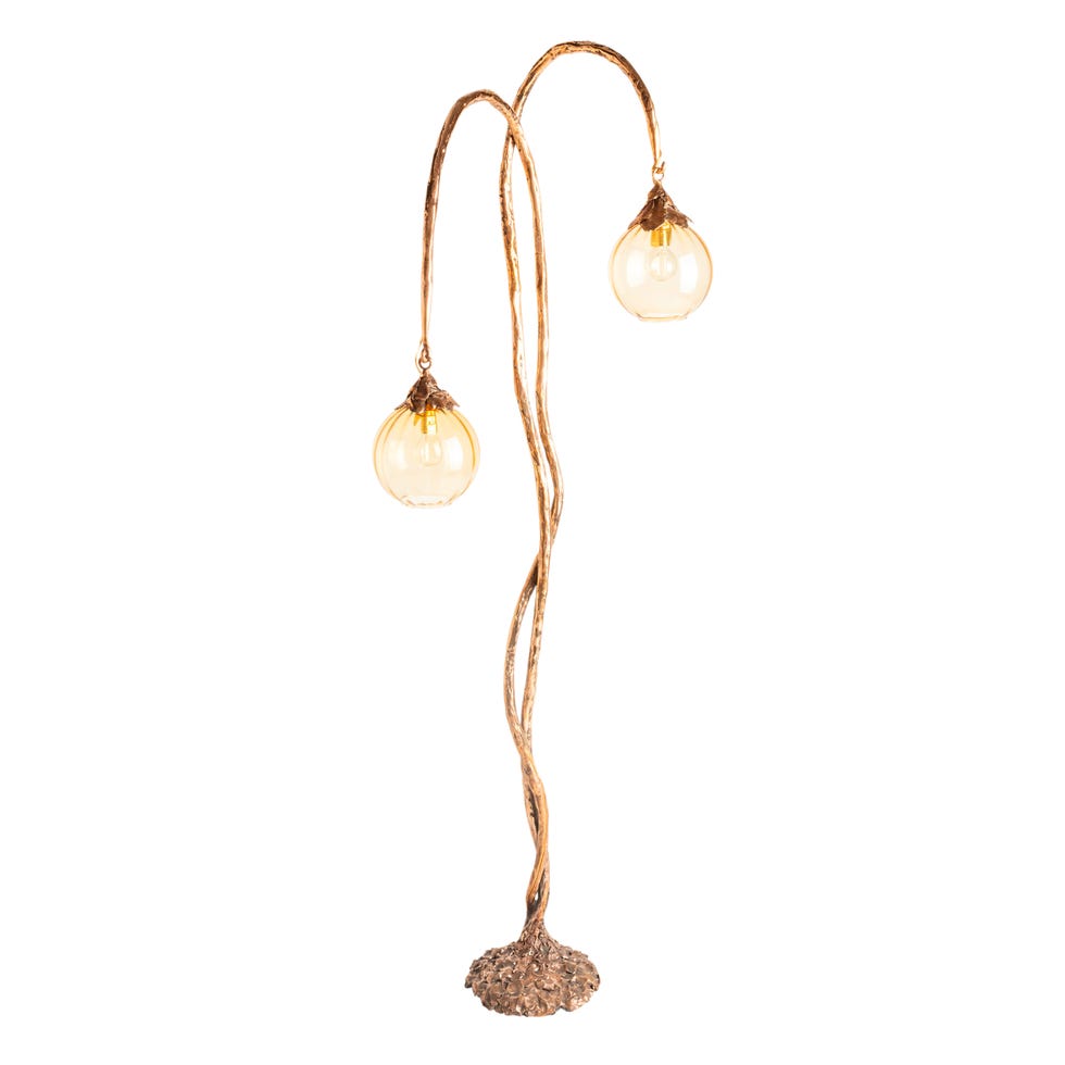 a floor lamp with two glass globes on curved branches