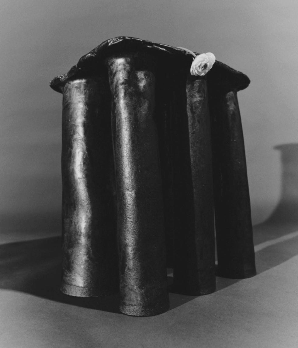 artistic sculpture featuring a multilegged structure with a decorative element