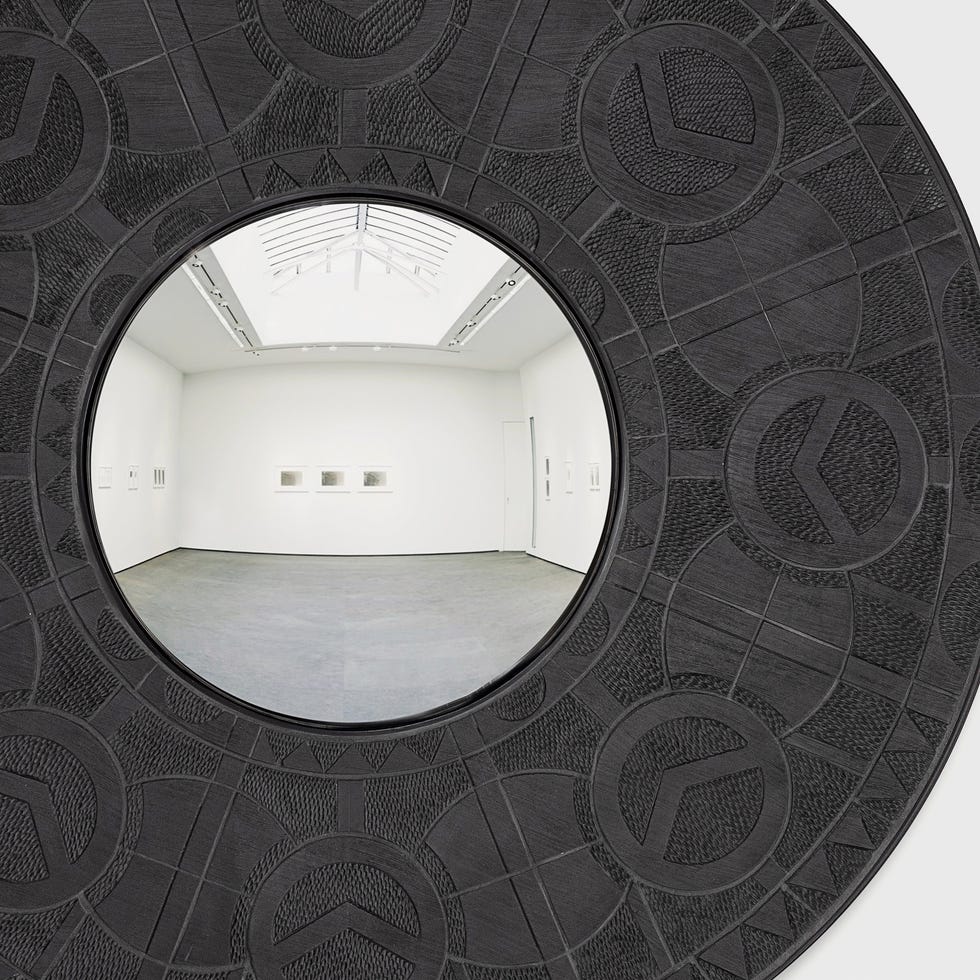a circular view framed by decorative elements showcasing an art gallery
