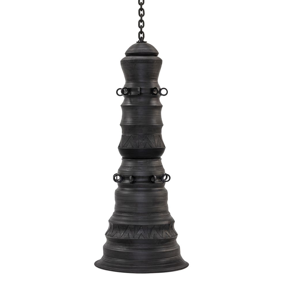 hanging decorative bell with a unique design featuring vertical grooves and round embellishments