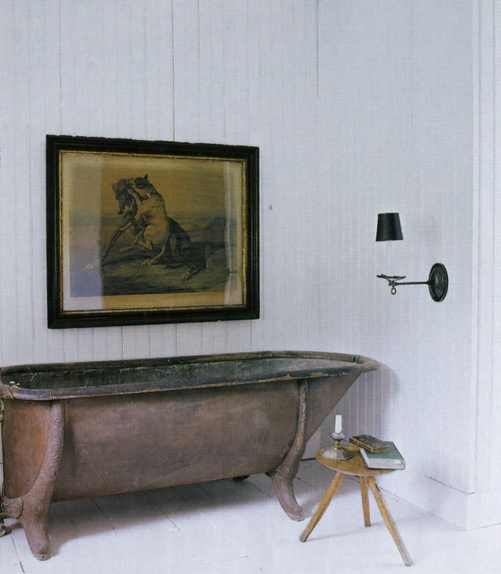 an oak rimmed galvanized metal tub milking stool and antique print in the master bath