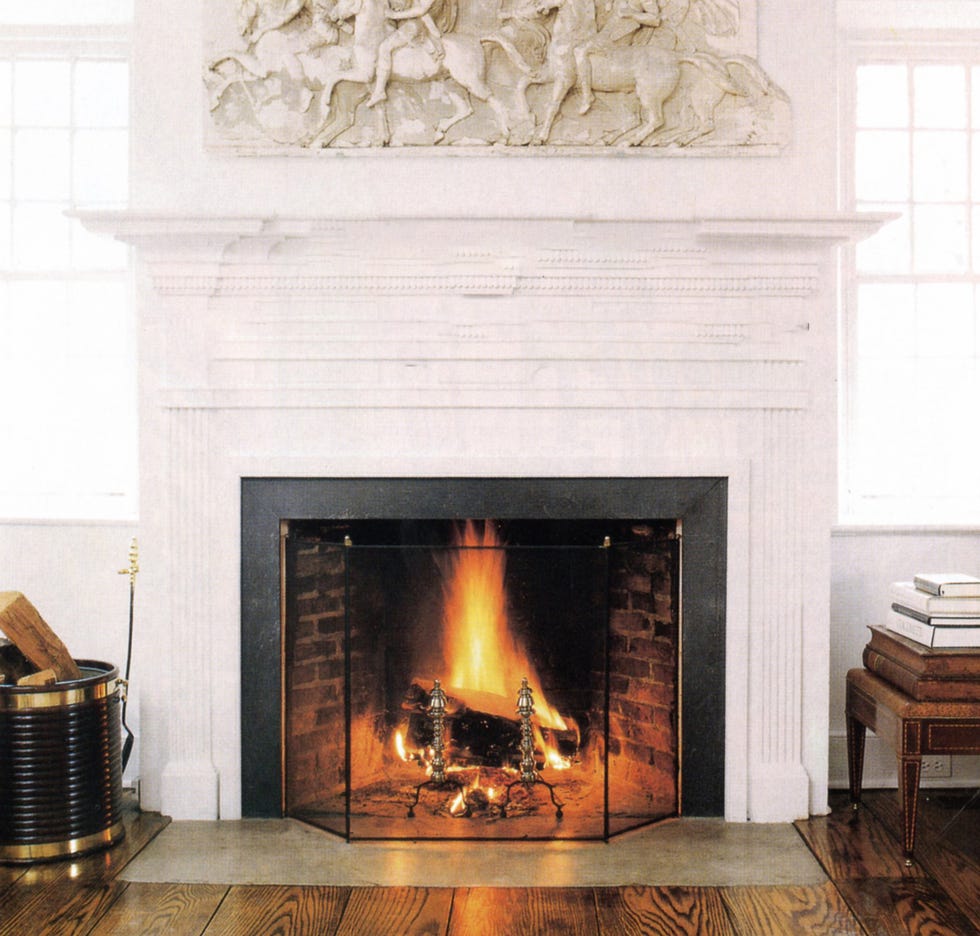 white fireplace with freize above it