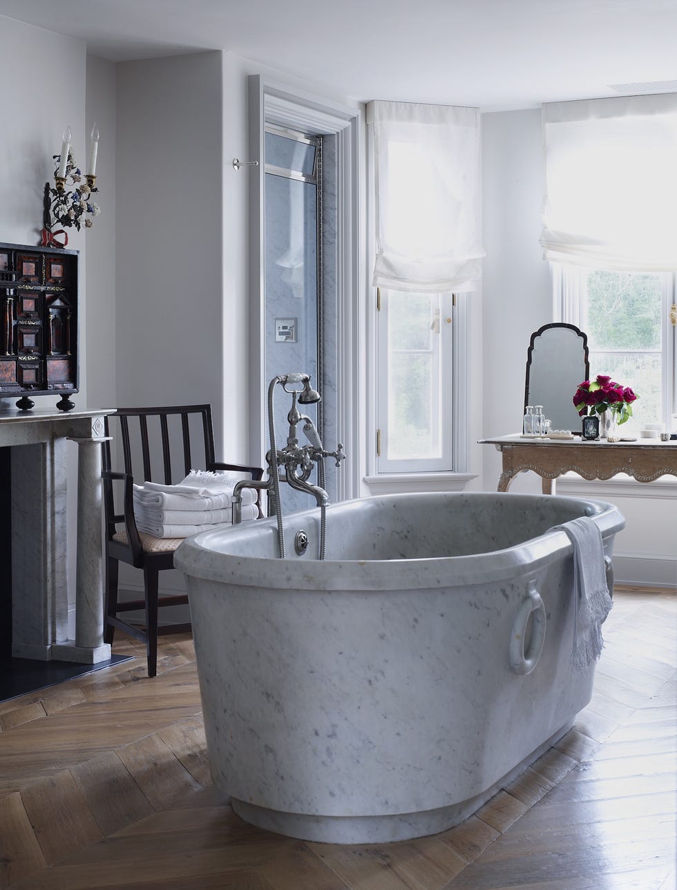 a circa 1850 marble tub from the water monopoly, with fittings by barber wilsons  co, in the master bath of this greenwich, ct home