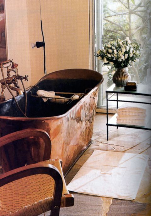 a 19th century copper bathtub and a wolf designed table in the master bath, which opens onto a private deck with an outdoor shower