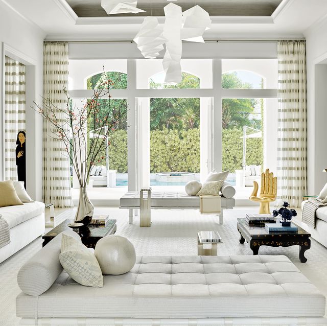 aman and meeks living room with white furniture and large doors