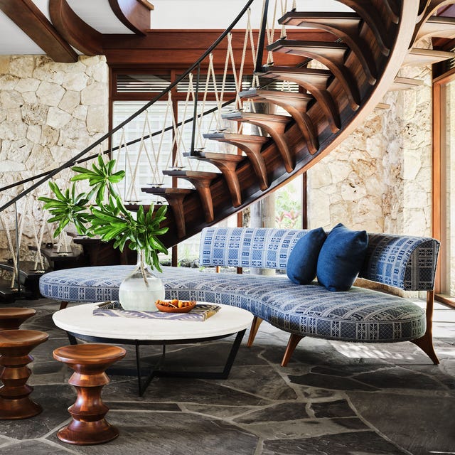 living room with wood spiral staircase designed by martyn lawrence bullard