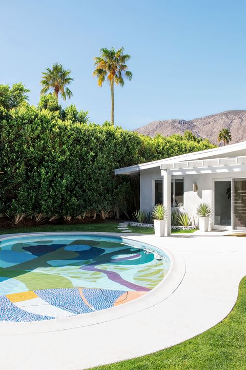 round in ground pool with a colorful geometric designed bottom