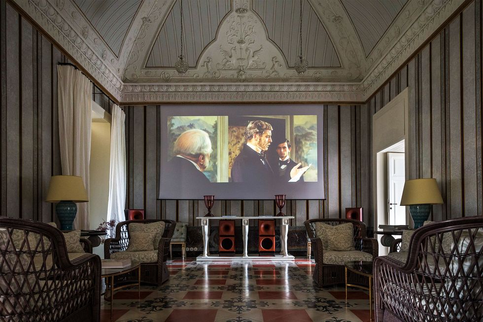 elaborate domed room with large screen with still of old movie the leopard displayed on it