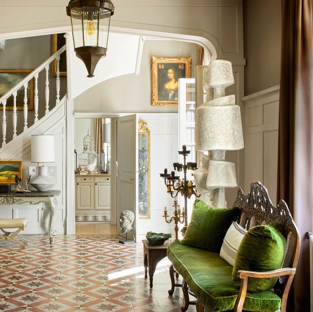 entryway of the manor with green chair and green sofa