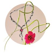 artistic set up of a serpent necklace black and white diamonds and a large red spinel stone at center intertwined with the stem of a red hibiscus like flower