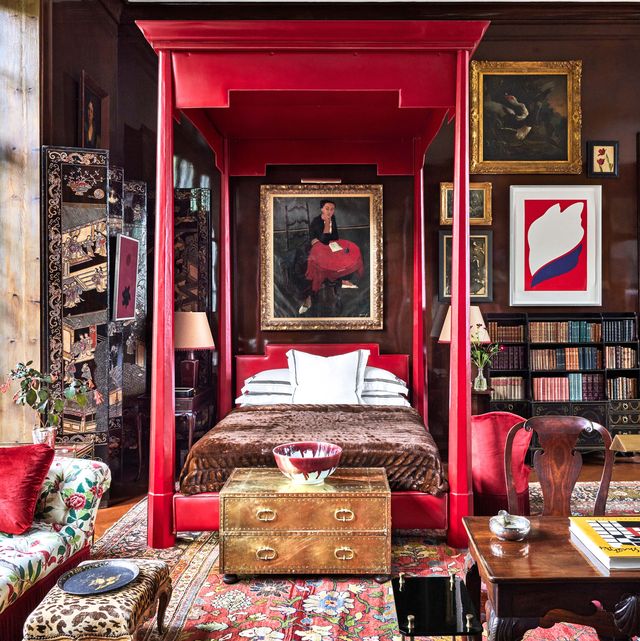 red canopy bed in living room designed by redd kaihoi