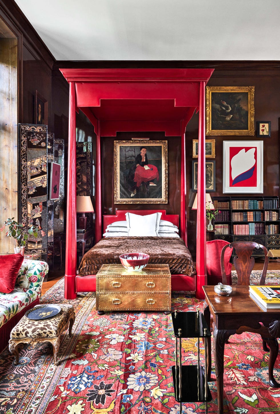 red canopy bed in living room designed by redd kaihoi