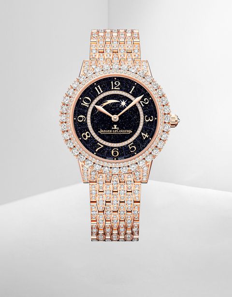 gold and diamond wristwatch with a black dial