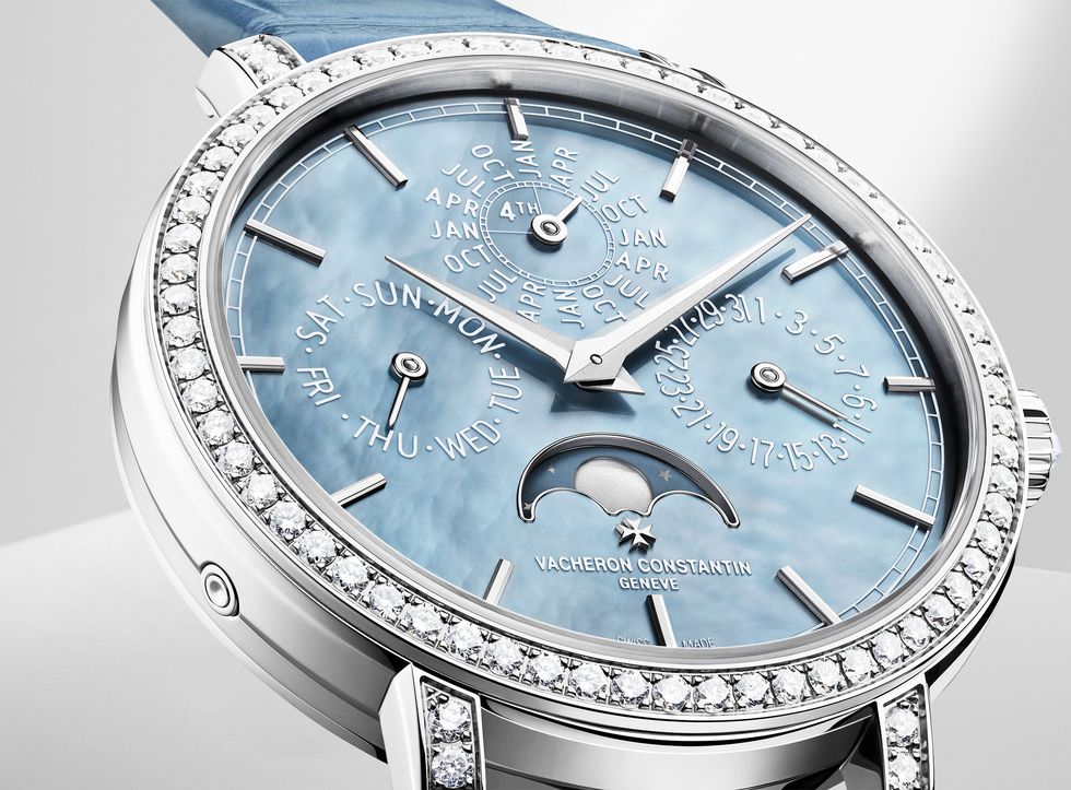 silver tone watch with light blue face and diamonds encircling the face and on the band