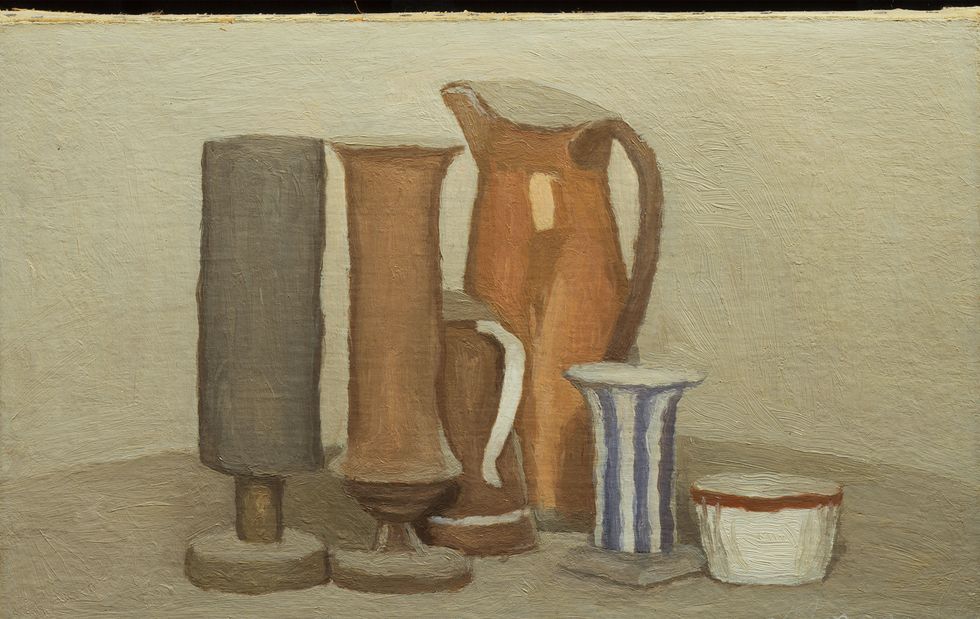 still life in neutral tones of various clay looking skinny jugs and containers