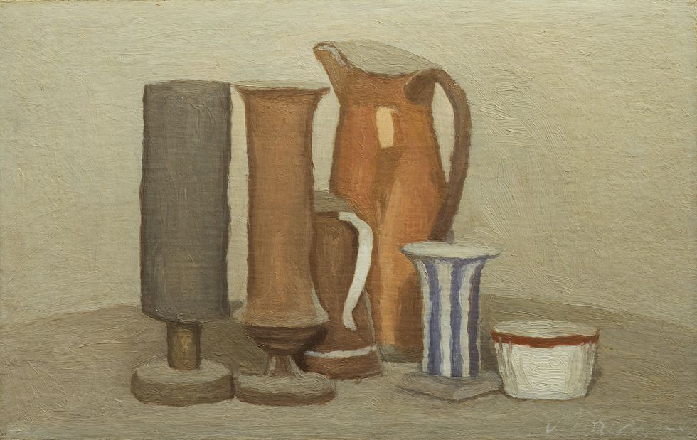 still life in neutral tones of various clay looking skinny jugs and containers