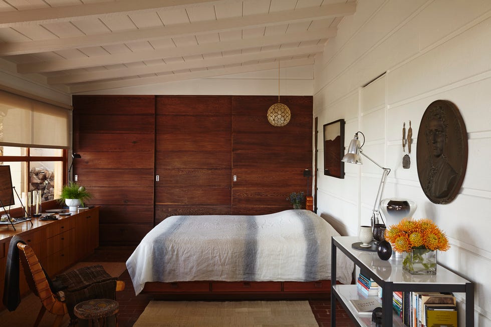 a modern bedroom featuring a bed decorative furniture and warm wood elements