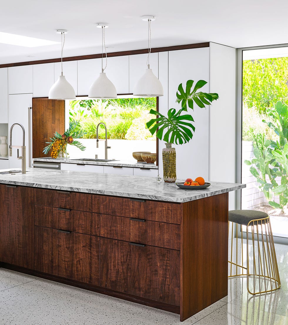 airy kitchen with island and three cone shaped pendants above it