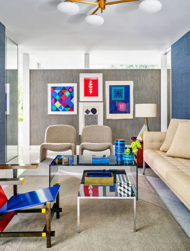 den room with modern furniture and coloful artwork on walls