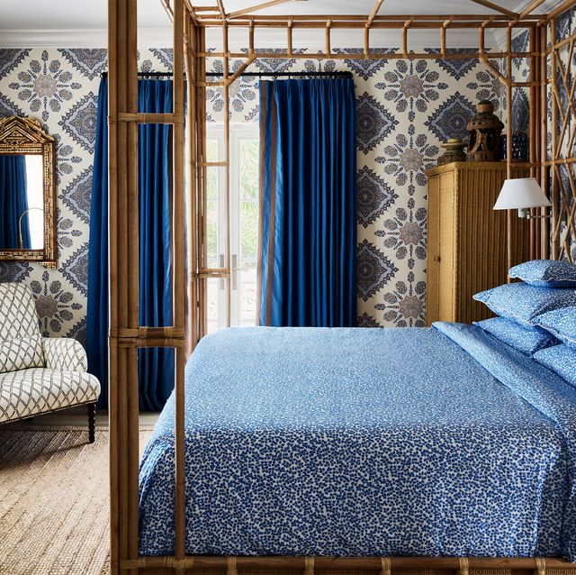 bedroom with blue bedspread and blue curtains in palm beach villa by mark d sikes
