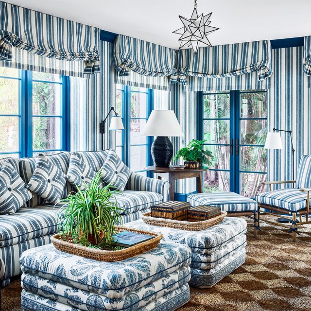 blue patterned living room with sofa and large ottomans