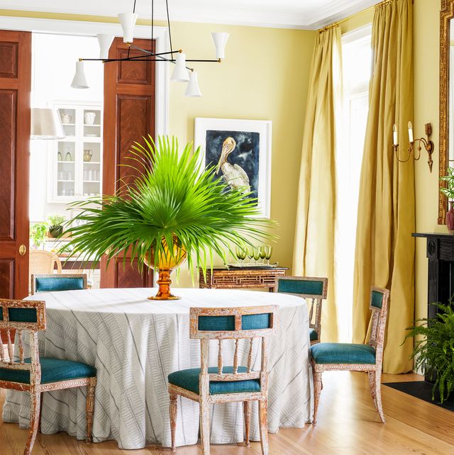 dining room with teal chairs and a big palm centerpiece by brockschmidt and coleman