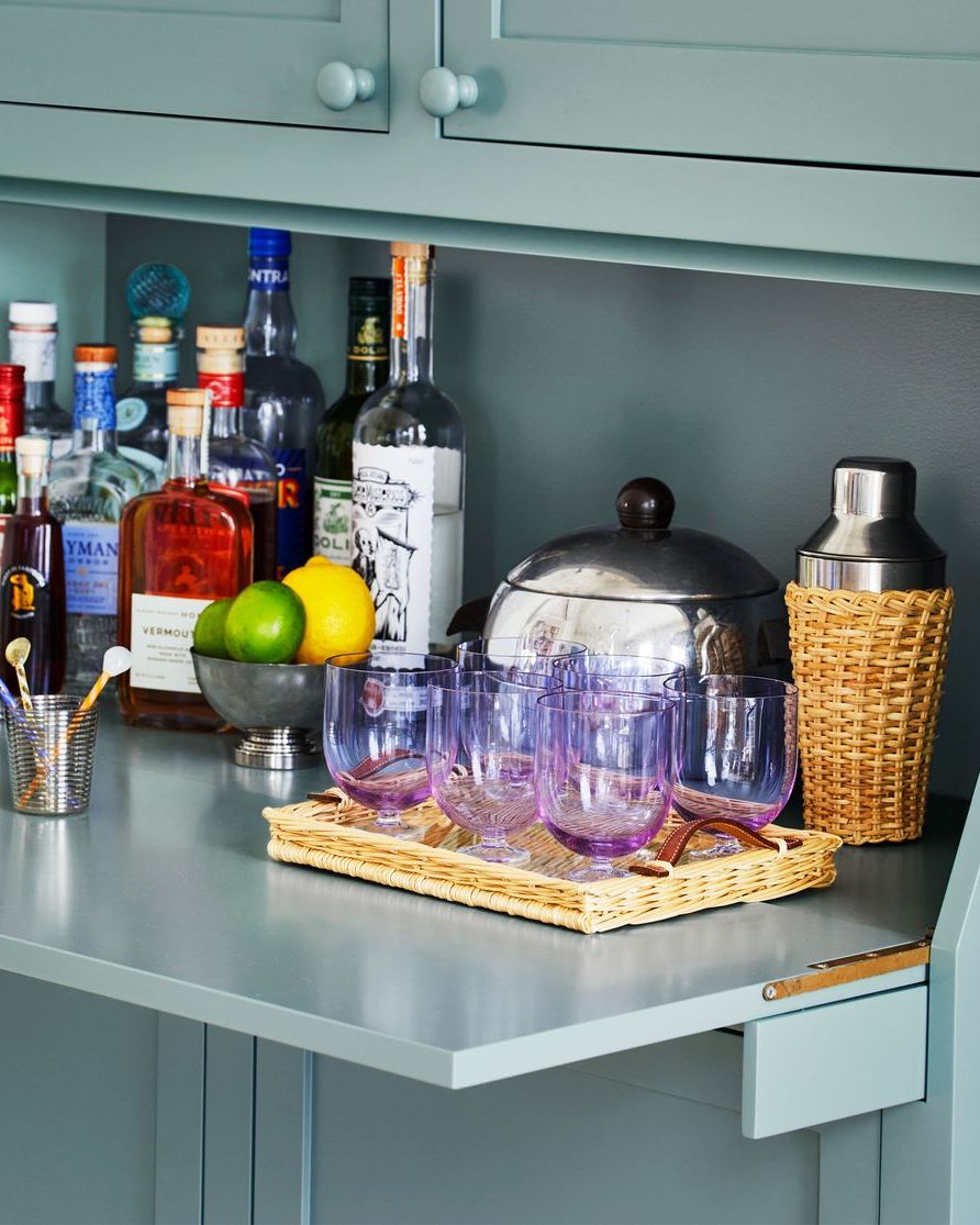 a counter with bottles and glasses on it